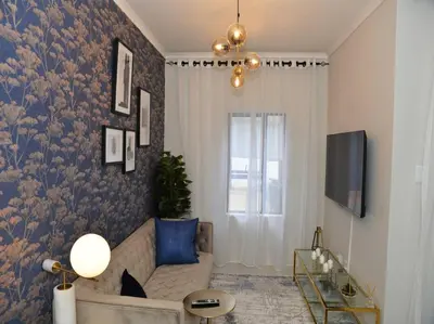 a living room with a couch and a window at Elcaro Luxury Villas-Royal Abode in Midrand