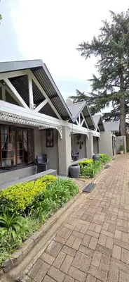 a row of houses with plants in front of them at Bo Kamer Guesthouse in Ermelo