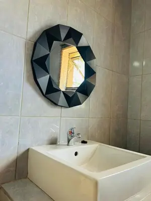 a bathroom with a sink and a mirror on the wall at SERENE ACCOMMODATION PALACE in Bela-Bela
