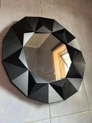 a mirror on a wall with a black at SERENE ACCOMMODATION PALACE in Bela-Bela