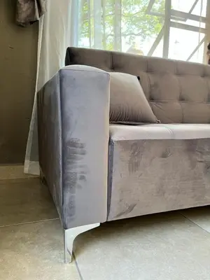 a leather couch sitting in a room with a window at SERENE ACCOMMODATION PALACE in Bela-Bela