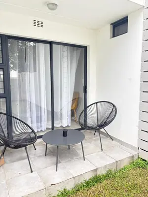 two chairs and a table on a patio at Monochrome View in Nelspruit