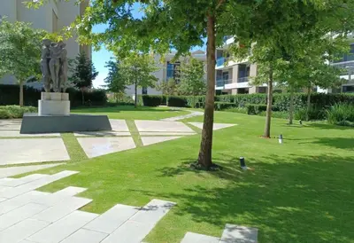 a statue in the middle of a park with a tree at Menlyn Maine Residences 721 in Pretoria