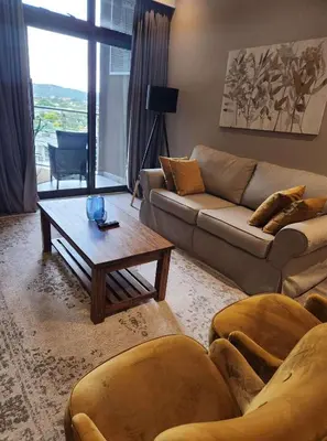 a living room with a couch and a coffee table at Menlyn Maine Residences 721 in Pretoria