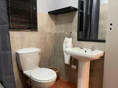 a bathroom with a toilet and a sink at Magalies House in Pretoria