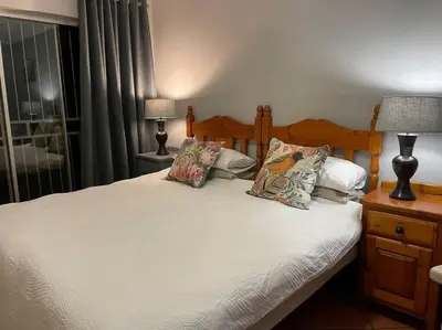 a bedroom with a bed with two pillows on it at Magalies House in Pretoria