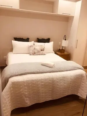 a bedroom with a large white bed with two pillows at Premier Lifestyle at The Regency in Pretoria