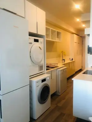 a kitchen with a washing machine and a washer at Premier Lifestyle at The Regency in Pretoria