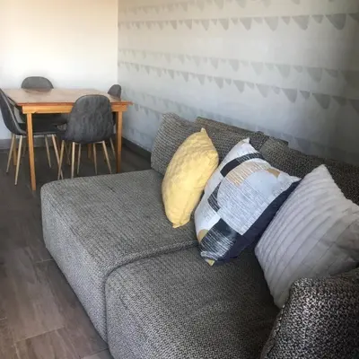 a couch with pillows on it in a living room at Premier Lifestyle at The Regency in Pretoria