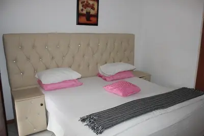 a bed with two pink pillows on top of it at Tzaneen Guest House in Tzaneen
