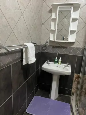a bathroom with a sink and a mirror at MorningMist Boutique Sun in Centurion