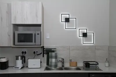 a kitchen counter with a sink and a microwave at Urbane- By LaSerene -Carlswald in Midrand