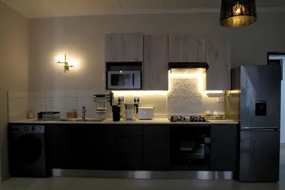 a kitchen with a stove and a refrigerator at Sublime - By LaSerene - Carlswald in Midrand