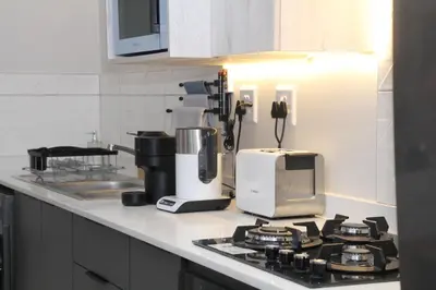 a kitchen counter with a coffee maker on a stove at Sublime - By LaSerene - Carlswald in Midrand
