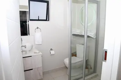 a bathroom with a toilet and a glass shower at Sublime - By LaSerene - Carlswald in Midrand
