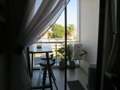 a room with a view of a balcony with a table and a window at Sublime - By LaSerene - Carlswald in Midrand