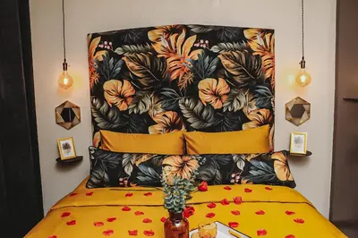 a headboard of a bed with flowers on it at Villa La'Vie in Witbank