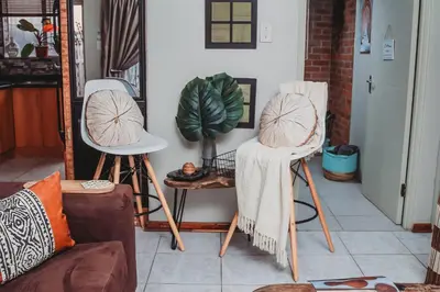 a living room with two chairs and a plant at Villa La'Vie in Witbank