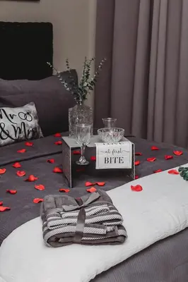 a bed with a table with red hearts on it at Villa La'Vie in Witbank