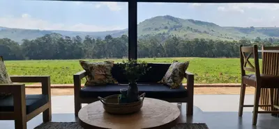 a living room with a couch and a table at Highland gate Golf estate Mountain view 780 in Dullstroom