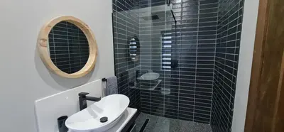 a bathroom with a toilet and a sink and a mirror at Highland gate Golf estate Mountain view 780 in Dullstroom