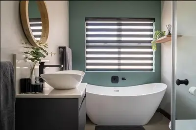 a bathroom with a white tub and a sink at Highland gate Golf estate Mountain view 780 in Dullstroom