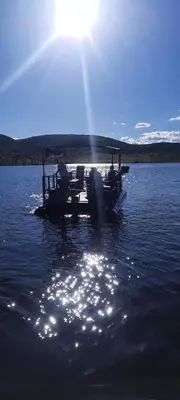 a boat in the water with the sun shining at Fish Eagle Bay View, Warmbaths in Bela-Bela