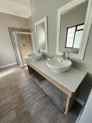 a bathroom with two sinks and a shower at Fish Eagle Bay View, Warmbaths in Bela-Bela