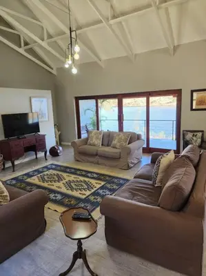 a living room with two couches and a television at Fish Eagle Bay View, Warmbaths in Bela-Bela