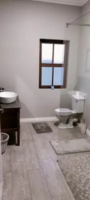 a bathroom with a toilet and a sink and a window at Fish Eagle Bay View, Warmbaths in Bela-Bela