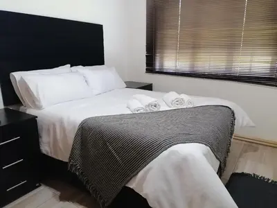a bedroom with a bed with two towels on it at Traveller's dream in Graskop
