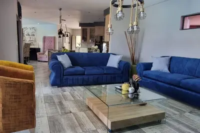a living room with blue couches and a coffee table at The Acres Home in White River