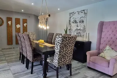 a dining room with a dining table and chairs at The Acres Home in White River