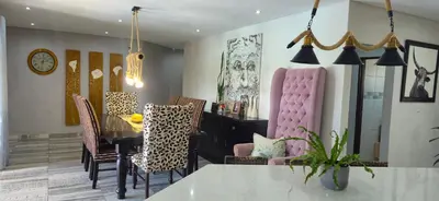 a dining room with a pink dining table and chairs at The Acres Home in White River