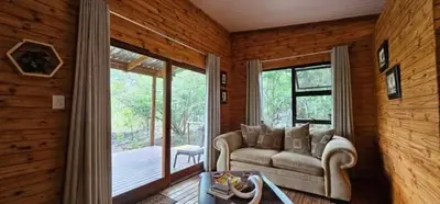 a living room with a couch and a large window at Marepe Flora Mountain View in Kampersrus AH