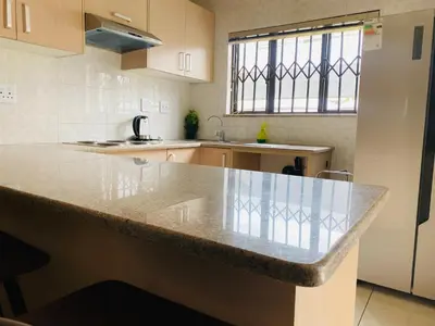 a kitchen with a large marble counter top at Siena Sun Apartment 10 in Midrand