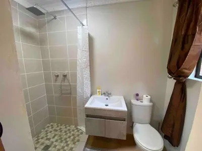 a bathroom with a toilet and a shower and a sink at Vlakkieskraal FarmStay - Bosvark Cabin in Bela-Bela
