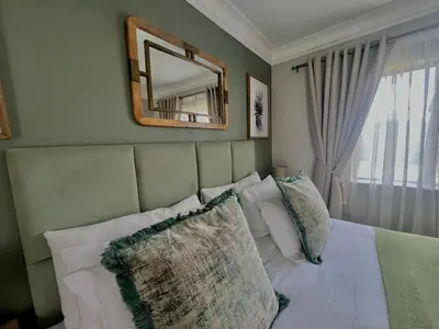 a bedroom with a bed with a mirror and pillows at Private room Skyfall Country Estate in Polokwane