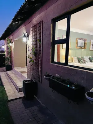 a purple house with two sinks and a window at Private room Skyfall Country Estate in Polokwane