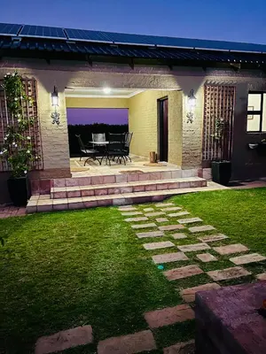 a patio of a house with a table and chairs at Private room Skyfall Country Estate in Polokwane