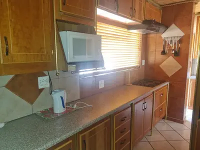 a kitchen with a counter top and a microwave at Bosveld Kuier Hoofhuis in Bela-Bela