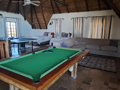 a living room with a pool table at Makhato Bush Lodge 6 in Bela-Bela