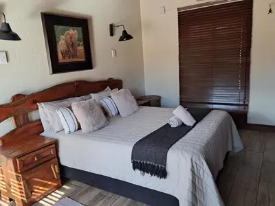 a bedroom with a large bed in a room at Makhato Bush Lodge 6 in Bela-Bela