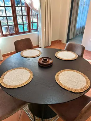 a black table with five plates on top of it at Winterfell Lephalale Lodge in Lephalale
