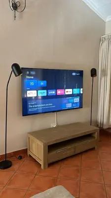 a flat screen tv hanging on a wall at Winterfell Lephalale Lodge in Lephalale