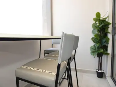 a table and chairs in a room with a plant at Elcaro Luxury Villas - The View in Midrand