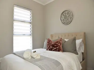 a bedroom with a bed with towels on it at Elcaro Luxury Villas - The View in Midrand