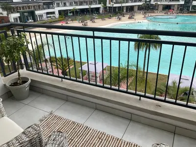 a balcony with a view of a swimming pool at The Blyde Stylish Homes in Pretoria