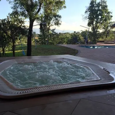 a hot tub with water in it next to a pool at Zebula Golf and Wildlife Estate - Moi Signature Exclusive Leisure Villas in Mabula