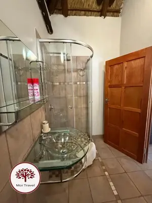 a bathroom with a glass shower with a glass table at Zebula Golf and Wildlife Estate - Moi Signature Exclusive Leisure Villas in Mabula